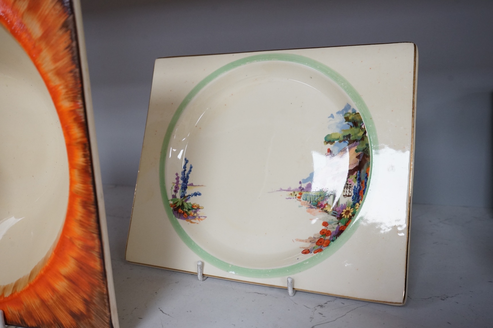 Three Clarice Cliff Bizarre ‘Biarritz’ dishes and a Wilkinson floral jug, largest 23cm wide